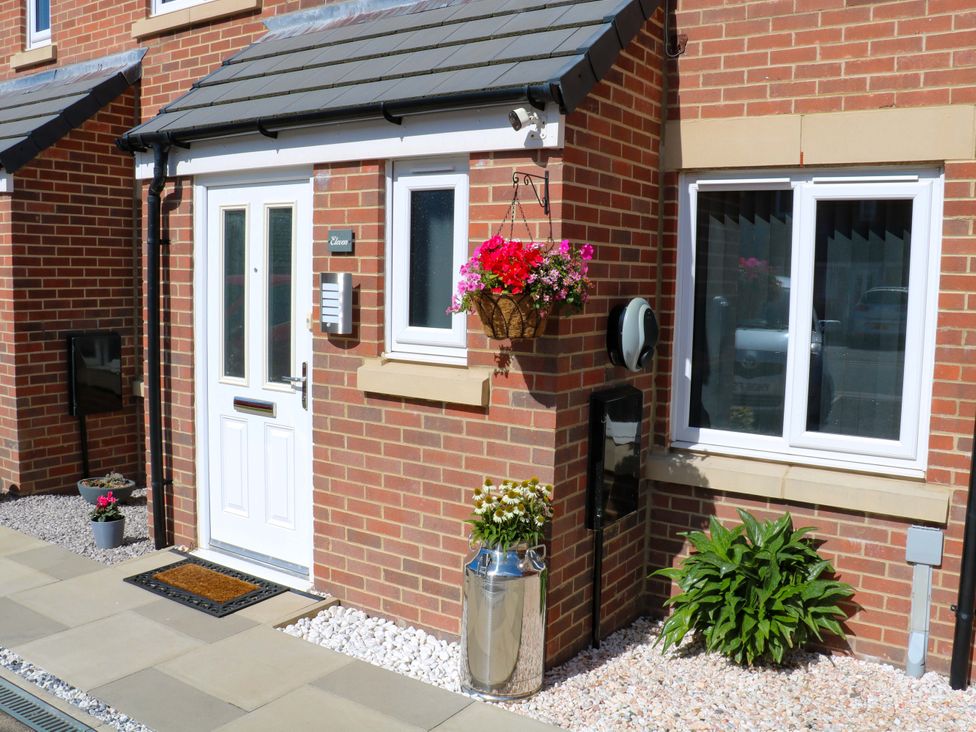 A front entrance with a door and flowers at Beach House Seaside Dunes Lytham St. Annes