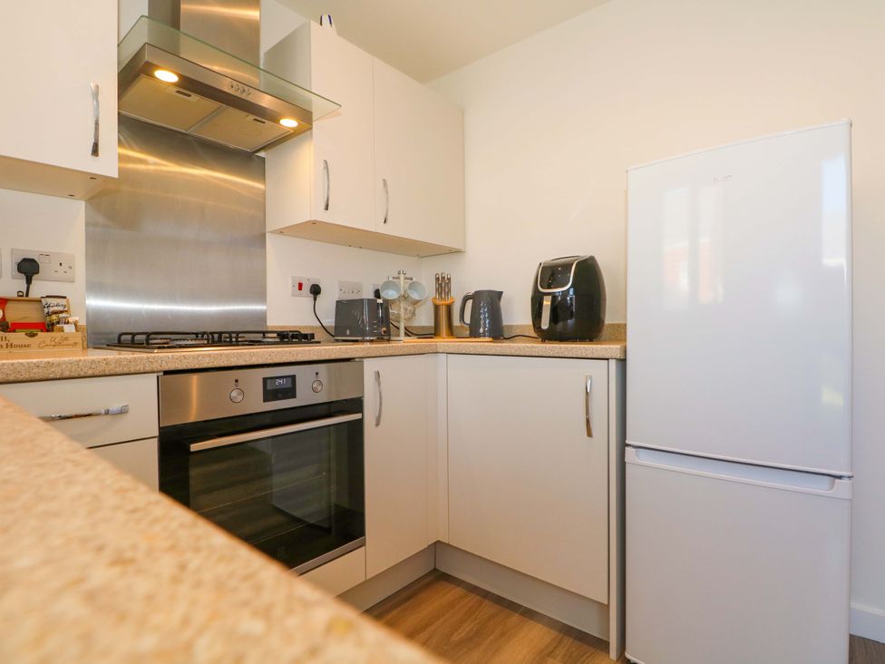 A kitchen with appliances and countertops at Beach House Seaside Dunes in Lytham St. Annes