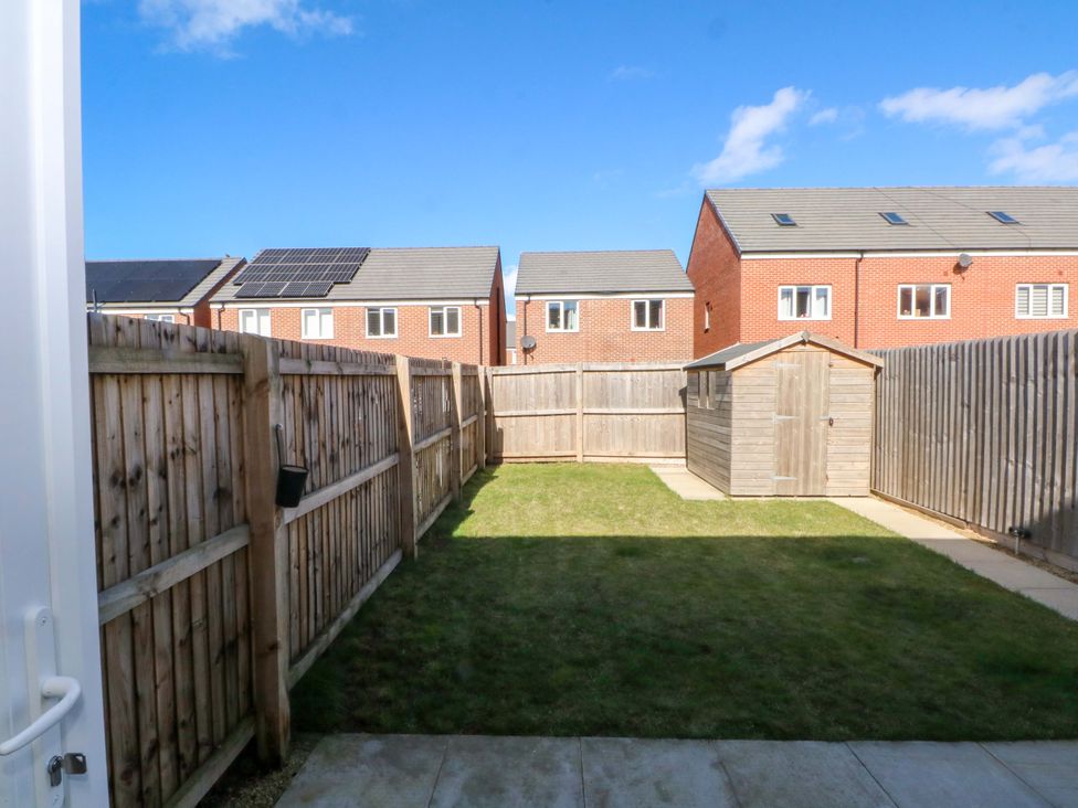 A garden with a shed and grass at Beach House Seaside Dunes in Lytham St. Annes