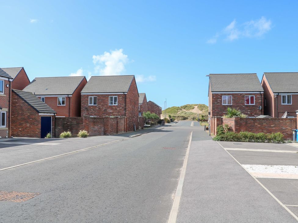 A street with houses on both sides near sand dunes at Beach House Seaside Dunes in Lytham St. Annes