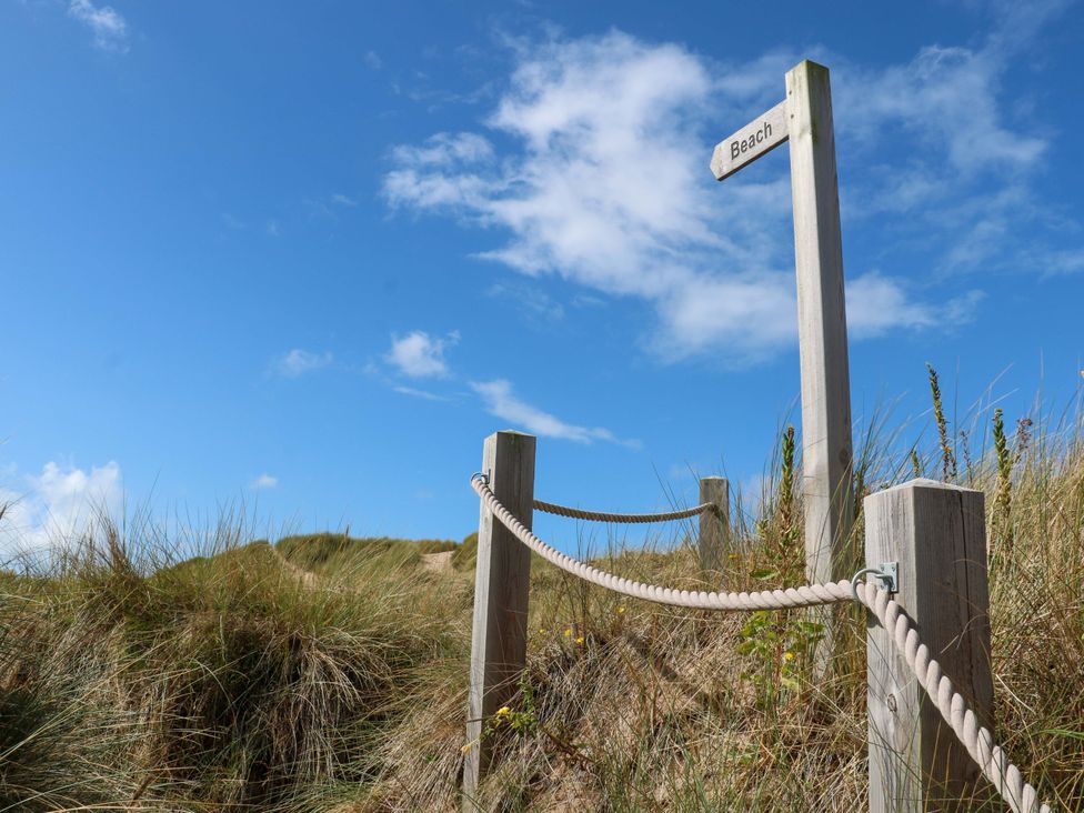 A signpost pointing to the beach on a pathway in Lytham St. Annes