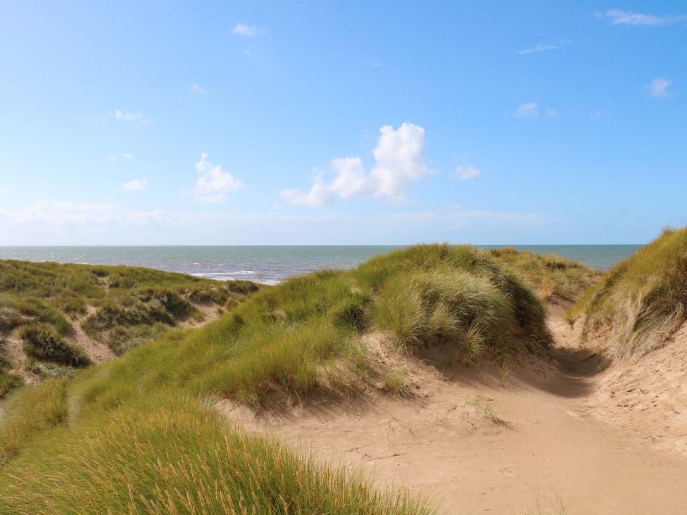 A view of sand dunes and ocean at Beach House Seaside Dunes Lytham St. Annes