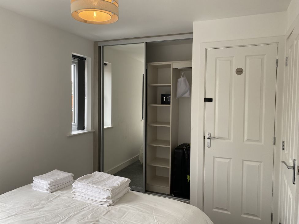 A bedroom with a bed and closet at Beach House Seaside Dunes in Lytham St. Annes