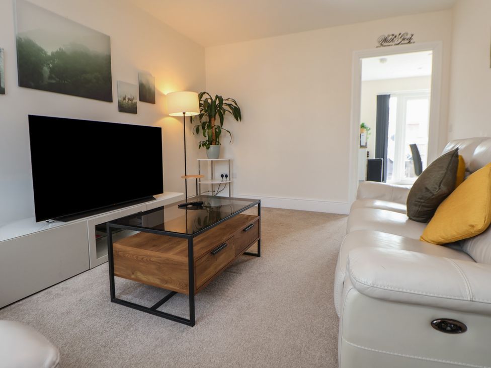 A living room with a television and coffee table at 29 Ernest Dawes Avenue Priorslee near Telford
