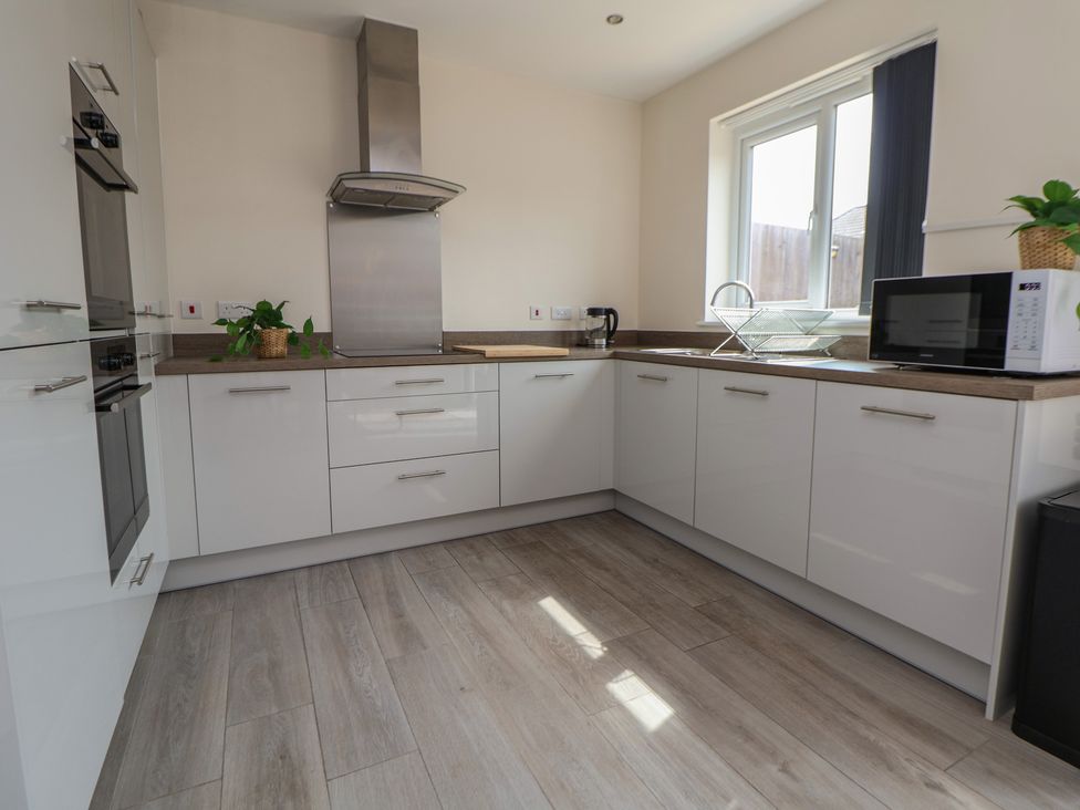 A kitchen with appliances and cabinets at 29 Ernest Dawes Avenue Priorslee near Telford
