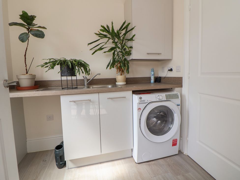 A utility room with a washing machine and plants at 29 Ernest Dawes Avenue Priorslee near Telford