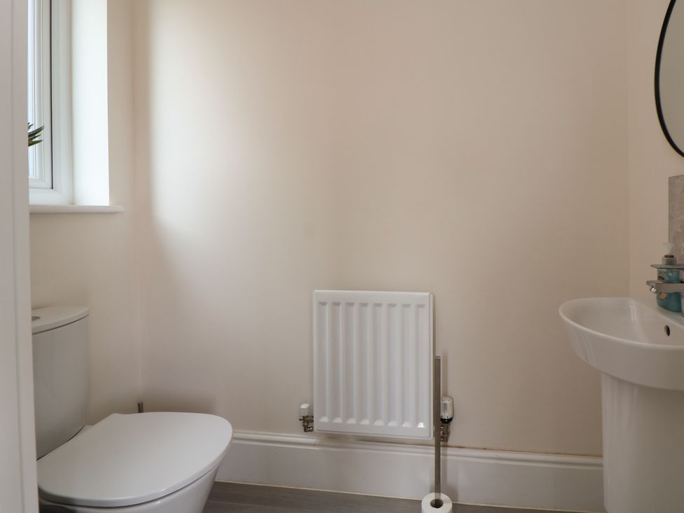 A bathroom with a toilet, sink, and radiator at 29 Ernest Dawes Avenue Priorslee near Telford