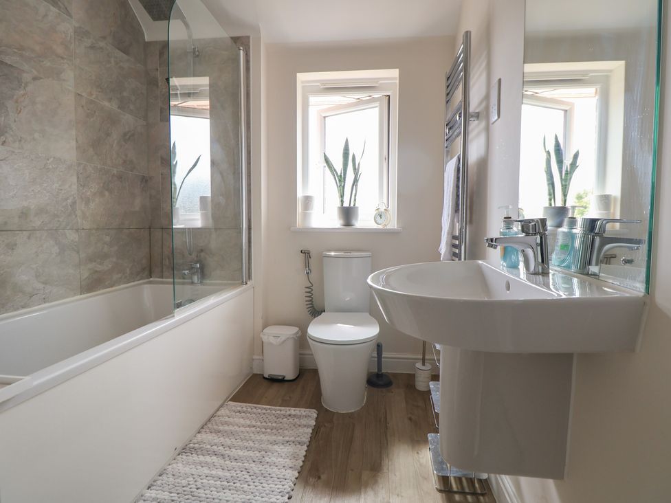 A bathroom with a bathtub, toilet, and sink at 29 Ernest Dawes Avenue Priorslee near Telford