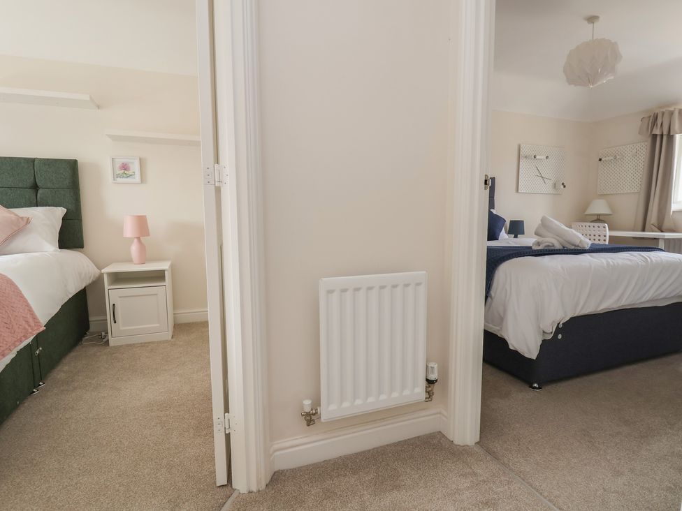 A view of two bedrooms with beds and furniture at 29 Ernest Dawes Avenue Priorslee near Telford