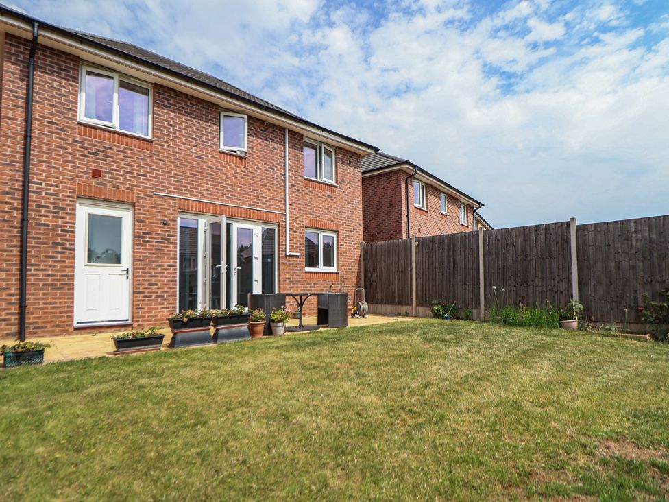 A garden with a brick house and table at 29 Ernest Dawes Avenue Priorslee near Telford