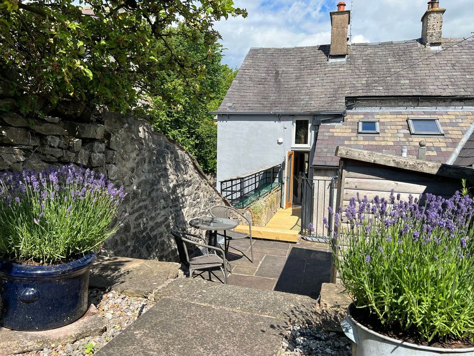 A patio with lavender plants and a table with chairs at Billy Whiskey's Tideswell