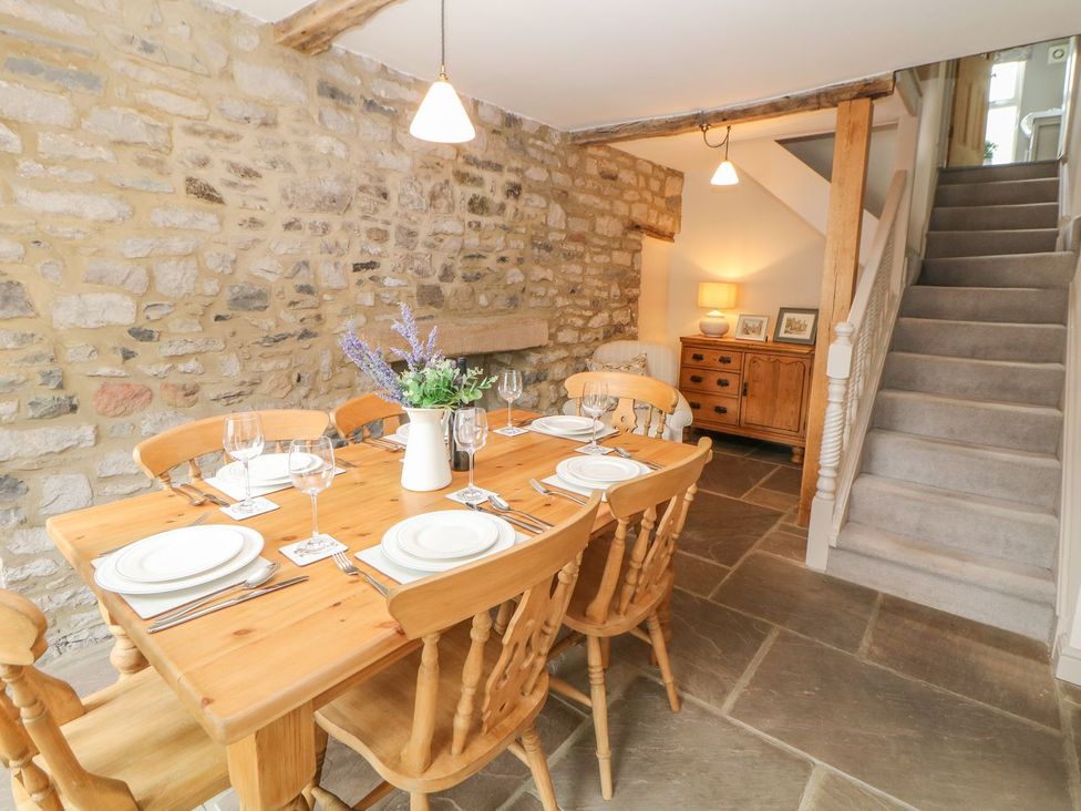 A dining room with a wooden table and chairs at Billy Whiskey's in Tideswell