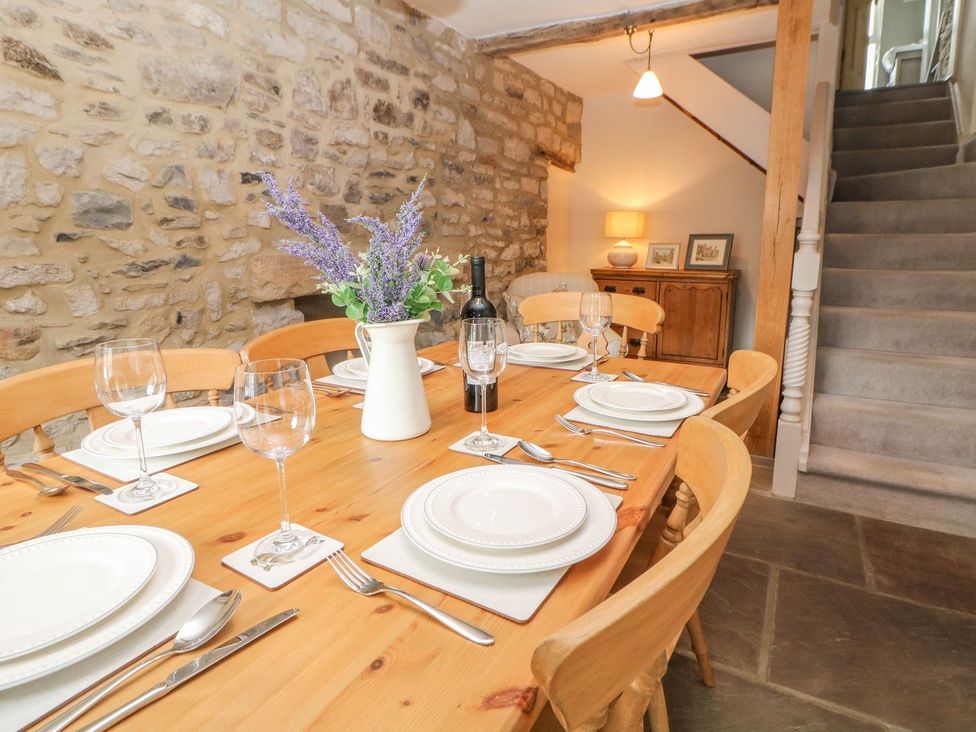 A dining room with a table set for meals at Billy Whiskey's in Tideswell