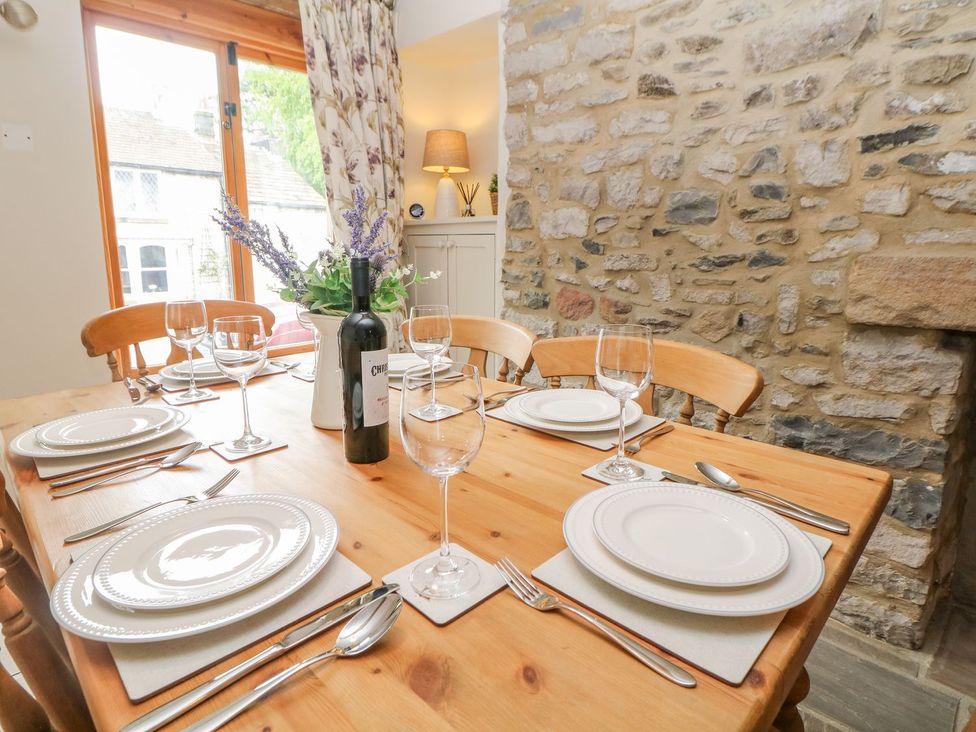 A dining room with a table set for a meal at Billy Whiskey's in Tideswell