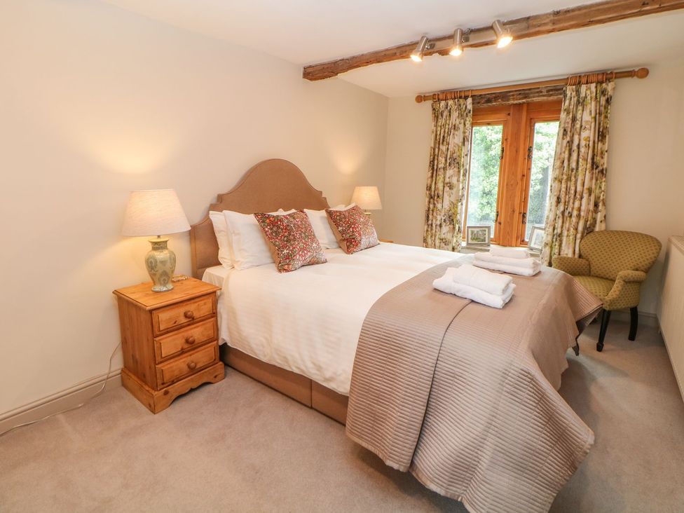 A bedroom with a bed and bedside lamp at Billy Whiskey's Tideswell