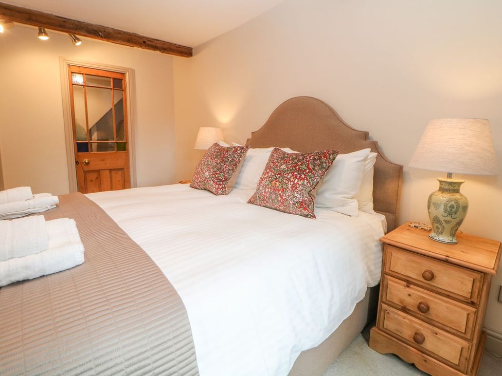 A bedroom with a bed and bedside table at Billy Whiskey's in Tideswell