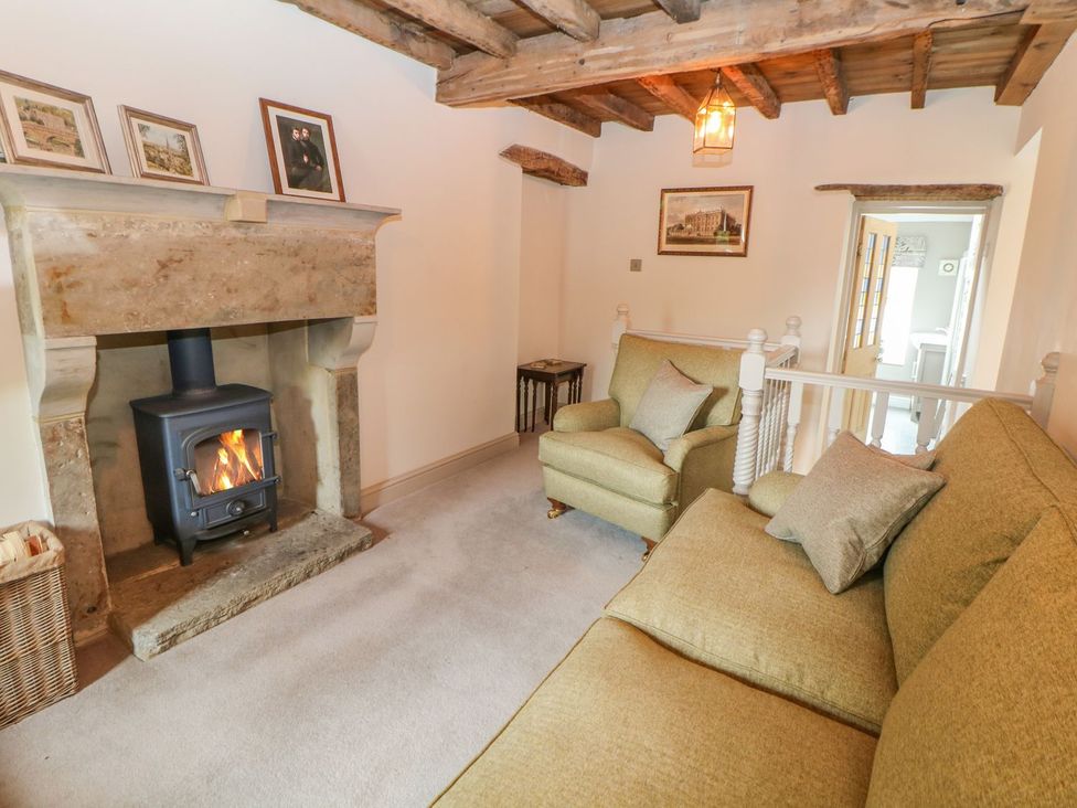 A snug with a fireplace and seating at Billy Whiskey's in Tideswell