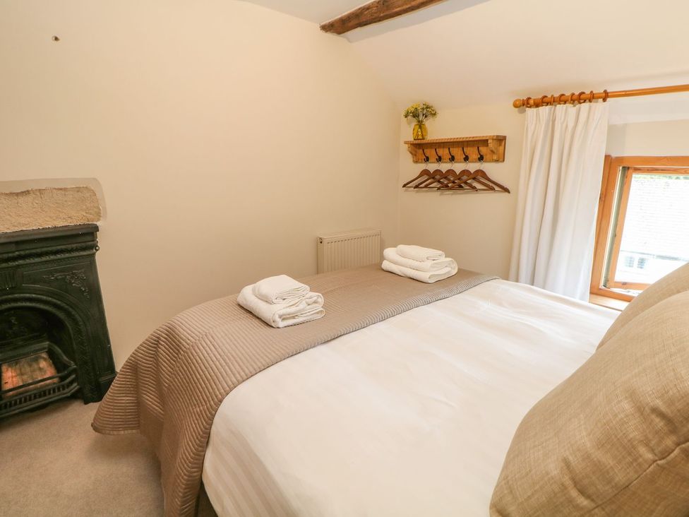 A bedroom with a bed and towels on top at Billy Whiskey's in Tideswell
