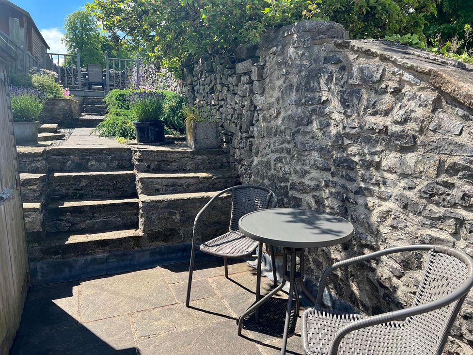 A garden with stone steps and seating area at Billy Whiskey's in Tideswell