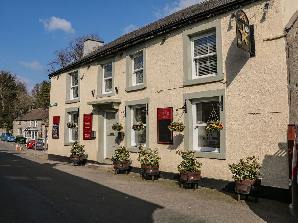 A pub exterior with signage and planters at The Star Inn in Tideswell