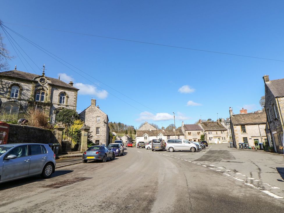 A street view with cars parked near buildings at Billy Whiskey's in Tideswell