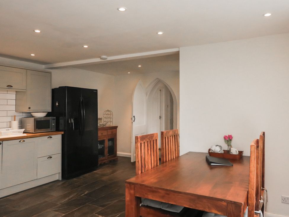 A kitchen with refrigerator and dining table at Tapps Lodge in Plymouth