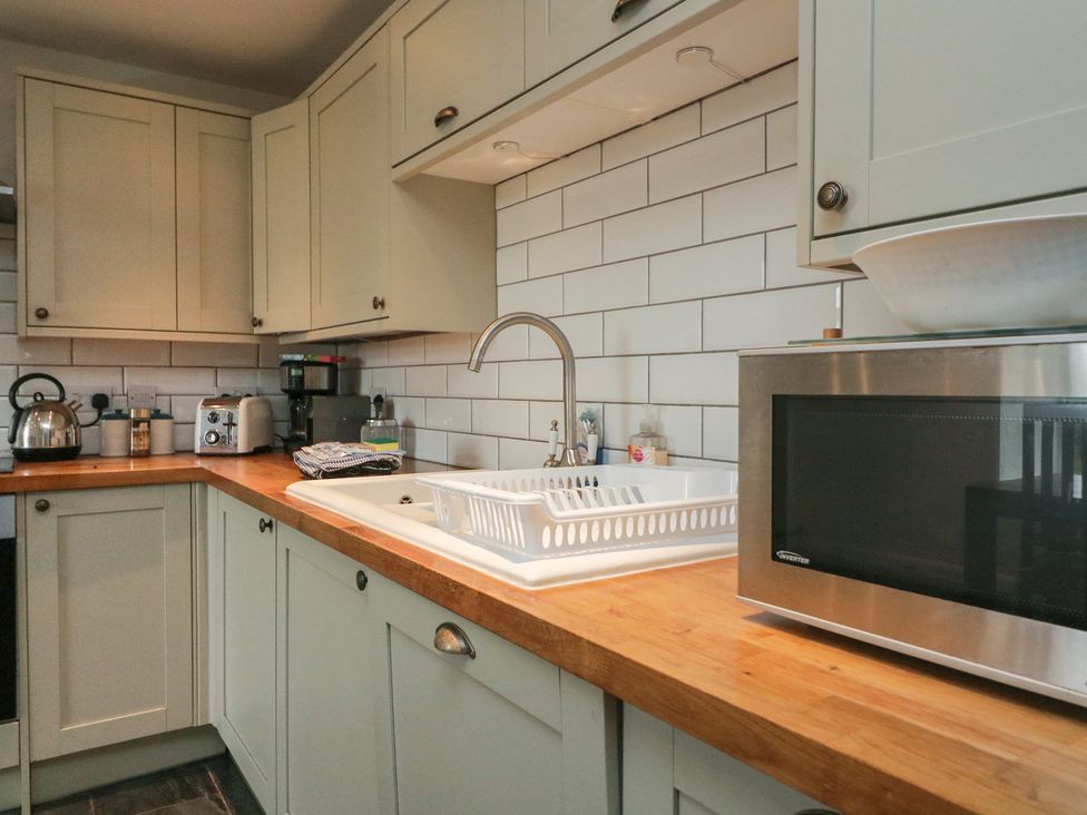 A kitchen with a sink and microwave at Tapps Lodge in Plymouth