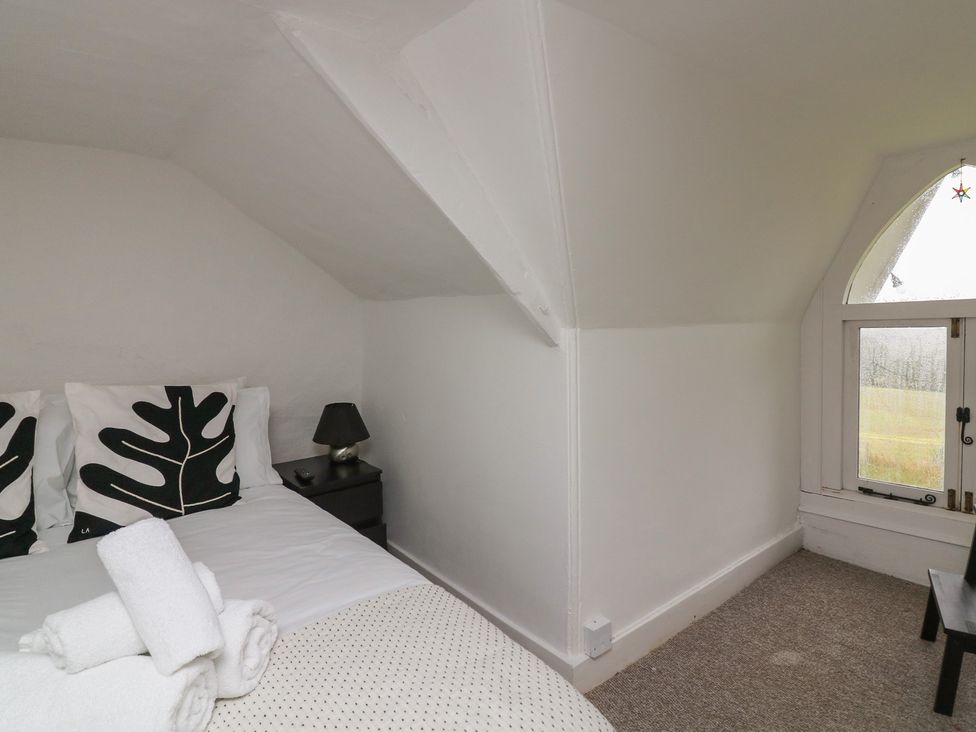 A bedroom with a bed and a window at Tapps Lodge in Plymouth