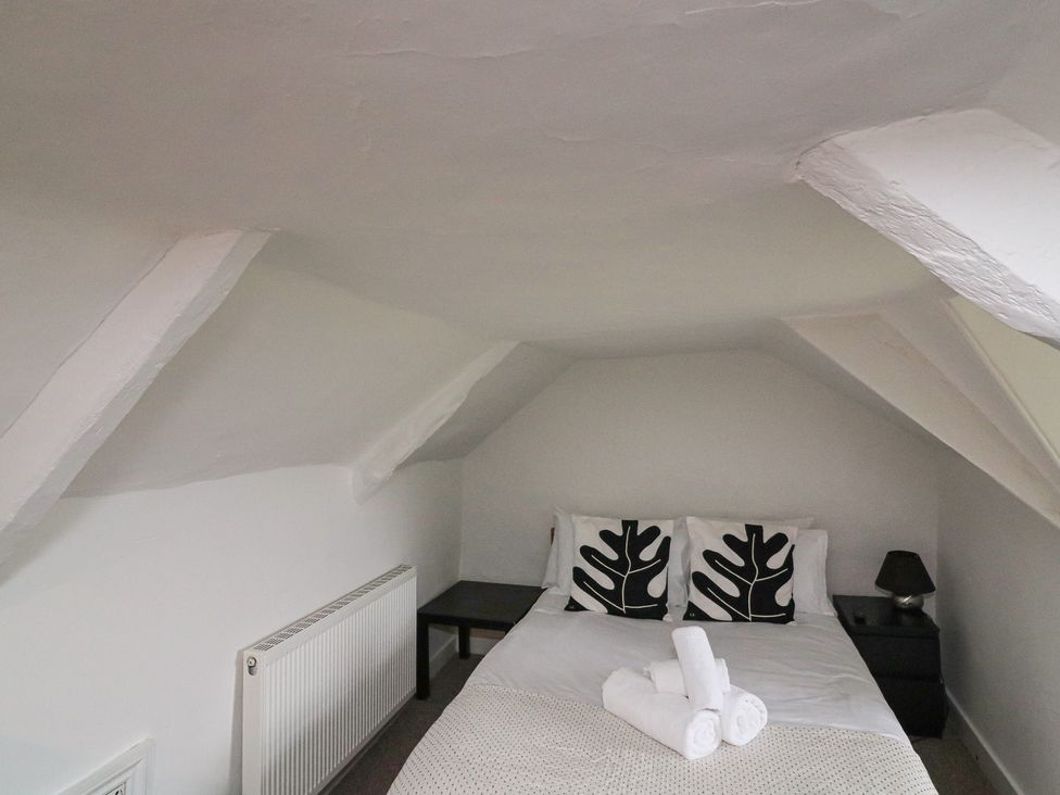 A bedroom with a bed and nightstand at Tapps Lodge in Plymouth