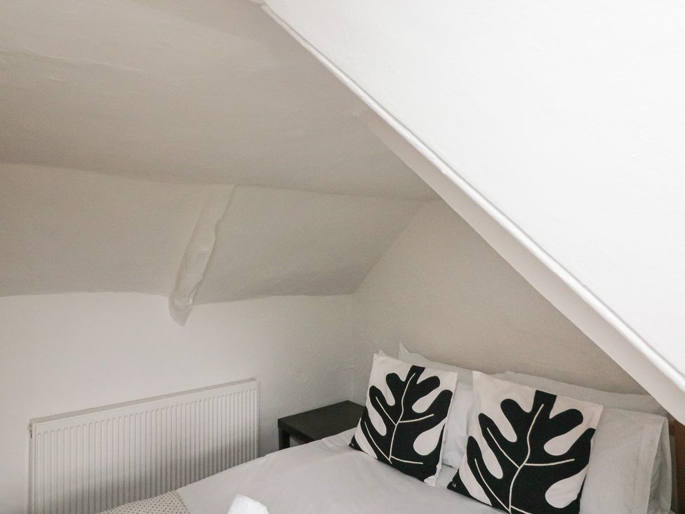 A bedroom with a bed and radiator at Tapps Lodge Plymouth