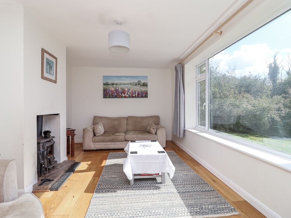 A living room with a sofa and coffee table at Tapps Lodge, Brixton near Yealmpton, South Devon