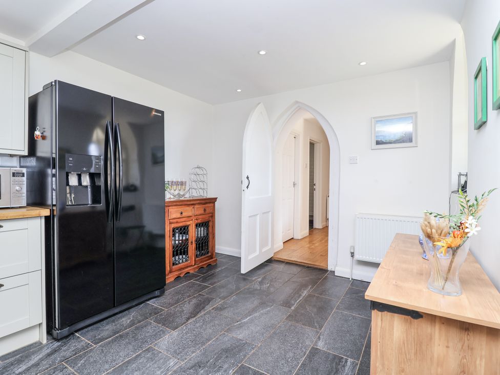 A kitchen with a refrigerator and sideboard at Tapps Lodge, Brixton near Yealmpton, South Devon