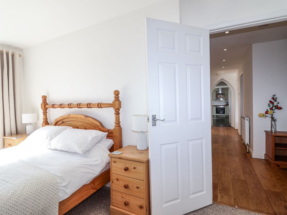 A bedroom with a bed and bedside tables at Tapps Lodge Brixton near Yealmpton, South Devon