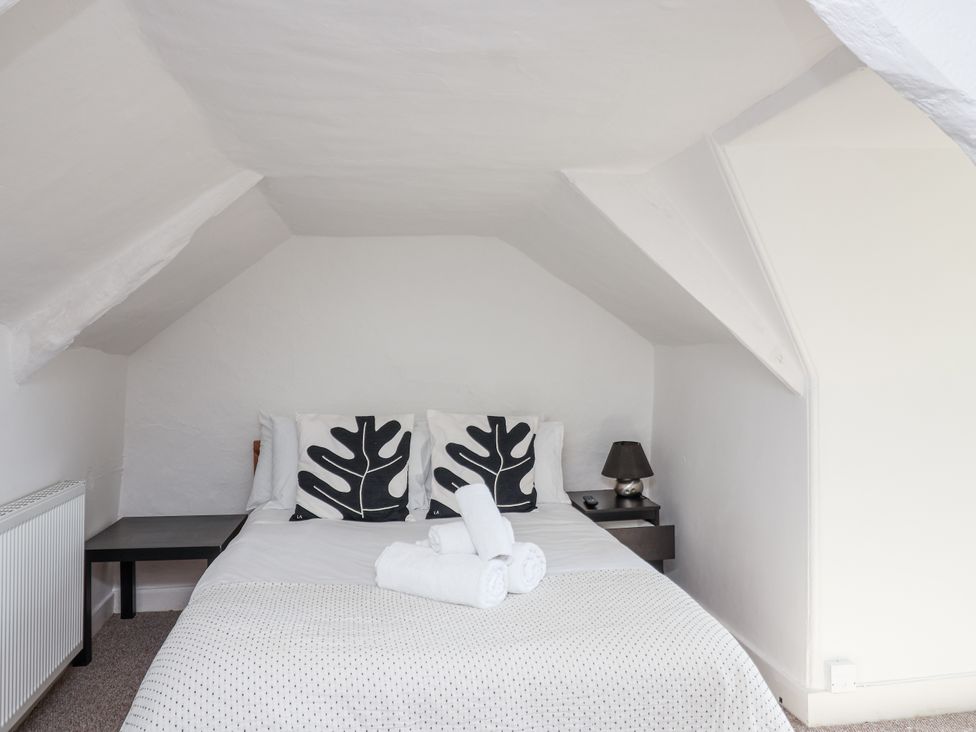 A bedroom with a bed and nightstand at Tapps Lodge Brixton near Yealmpton, South Devon