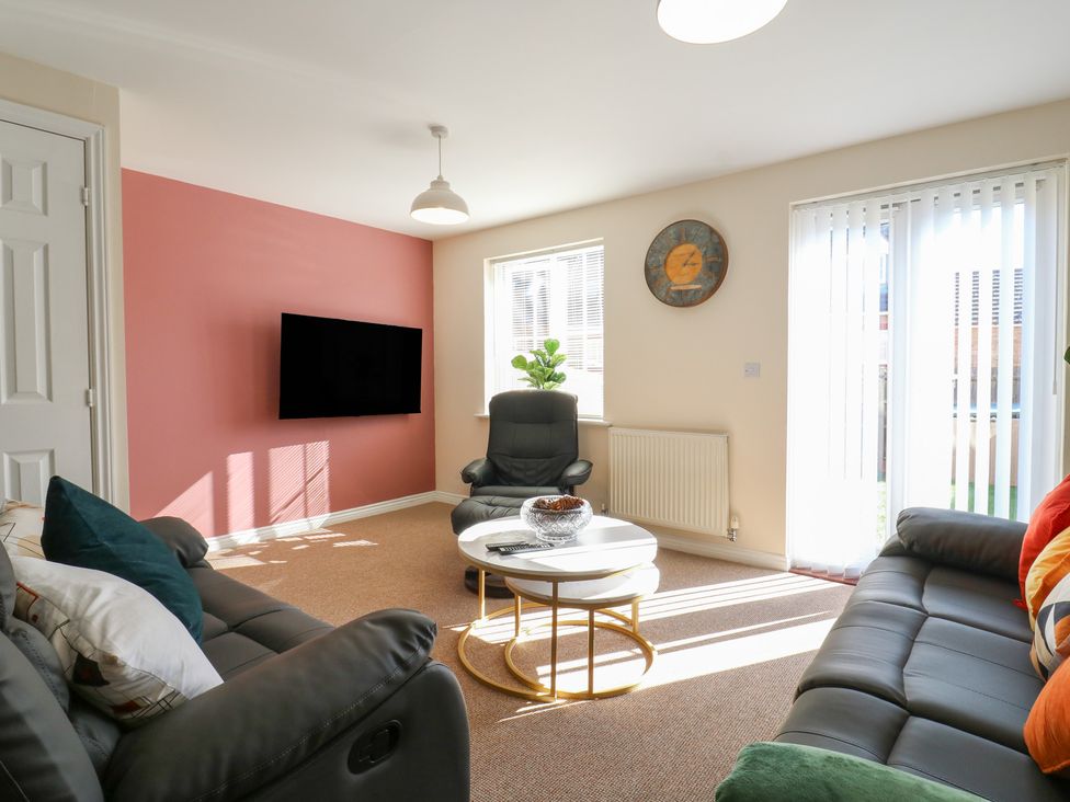 A living room with a sofa and coffee table at Gem Relax