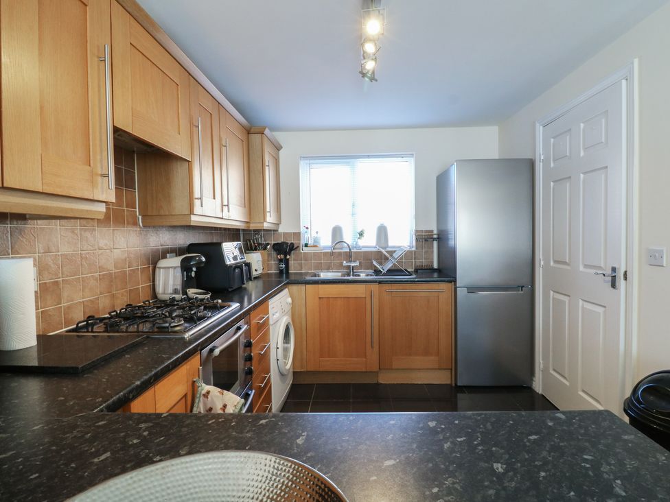 A kitchen with appliances and cabinets at Gem Relax