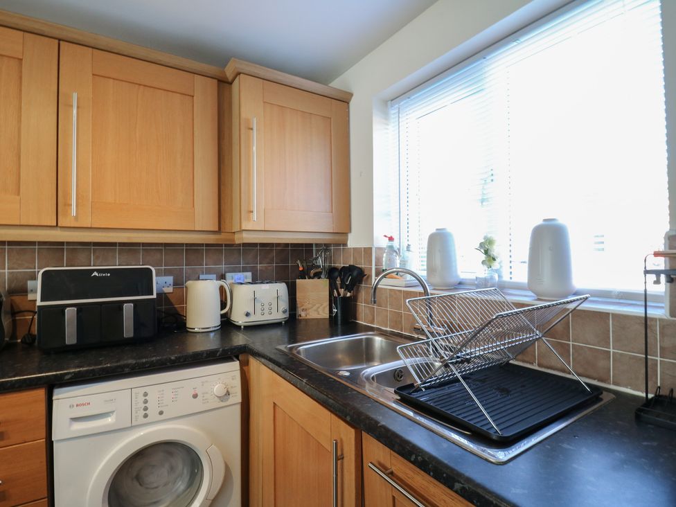 A kitchen with cabinets and appliances at Gem Relax