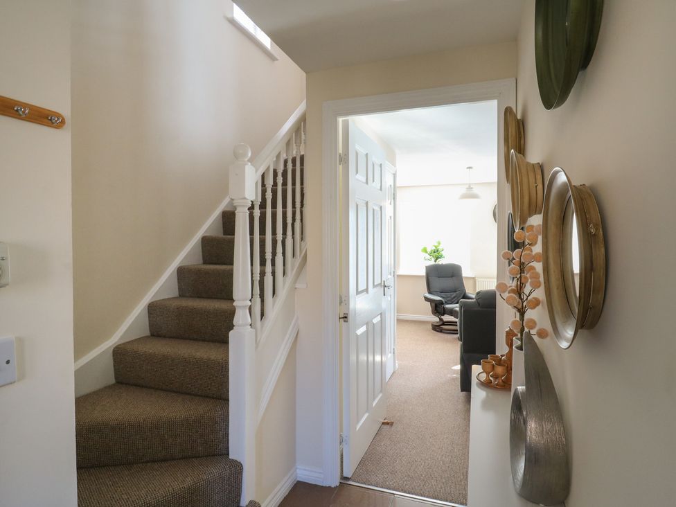 A hallway with stairs and a door leading to another room at Gem Relax