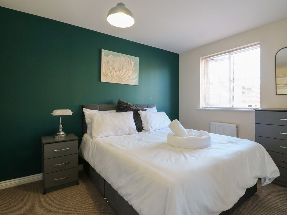 A bedroom with a bed and nightstand at Gem Relax in 