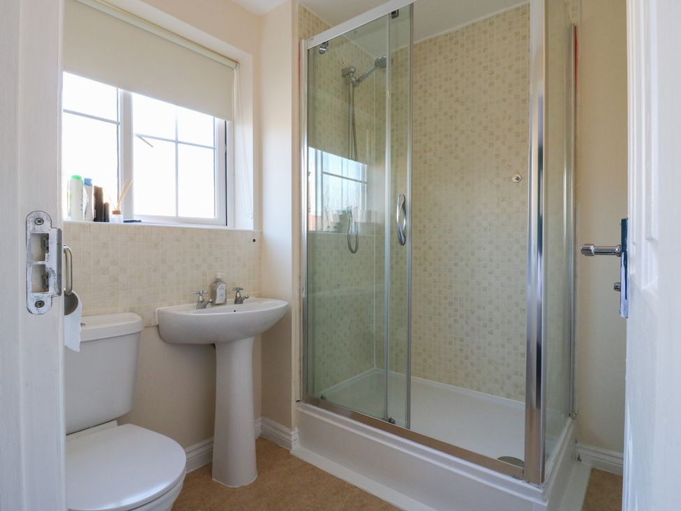 A bathroom with a toilet, sink, and shower at Gem Relax