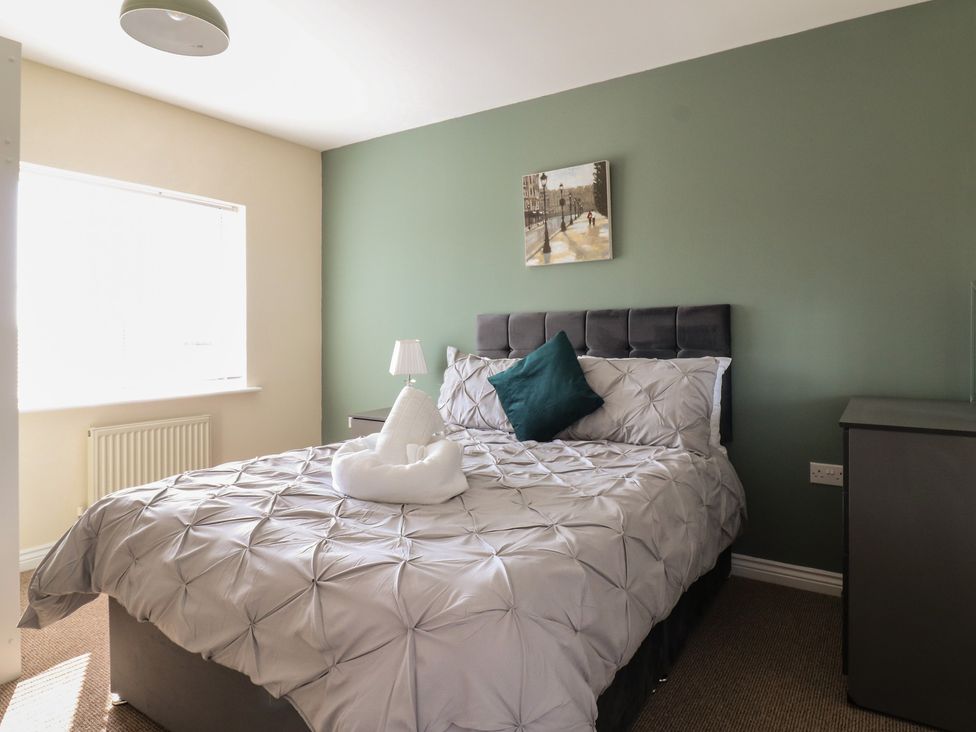 A bedroom with a bed and bedside lamp at Gem Relax in 