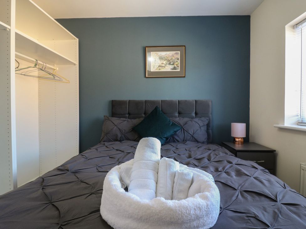 A bedroom with a bed and bedside table at Gem Relax