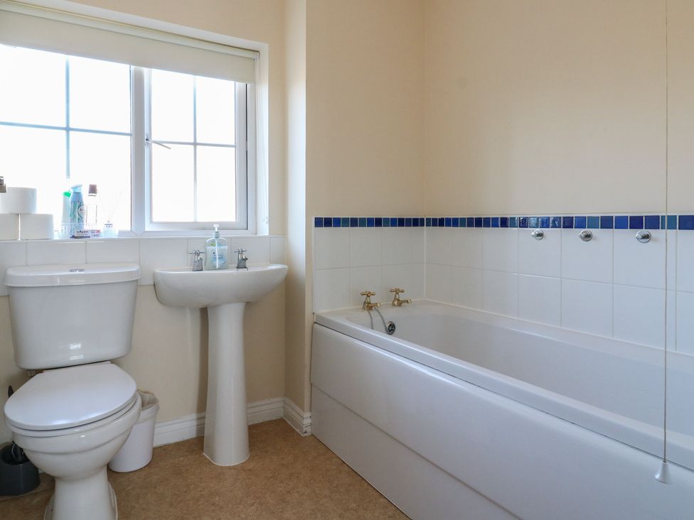 A bathroom with toilet, sink, and bathtub at Gem Relax