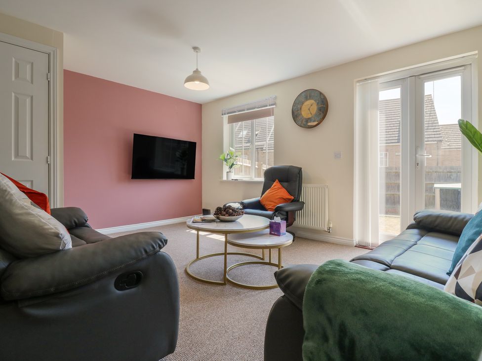A living room with a sofa and coffee table at Gem Relax in Leighton Buzzard