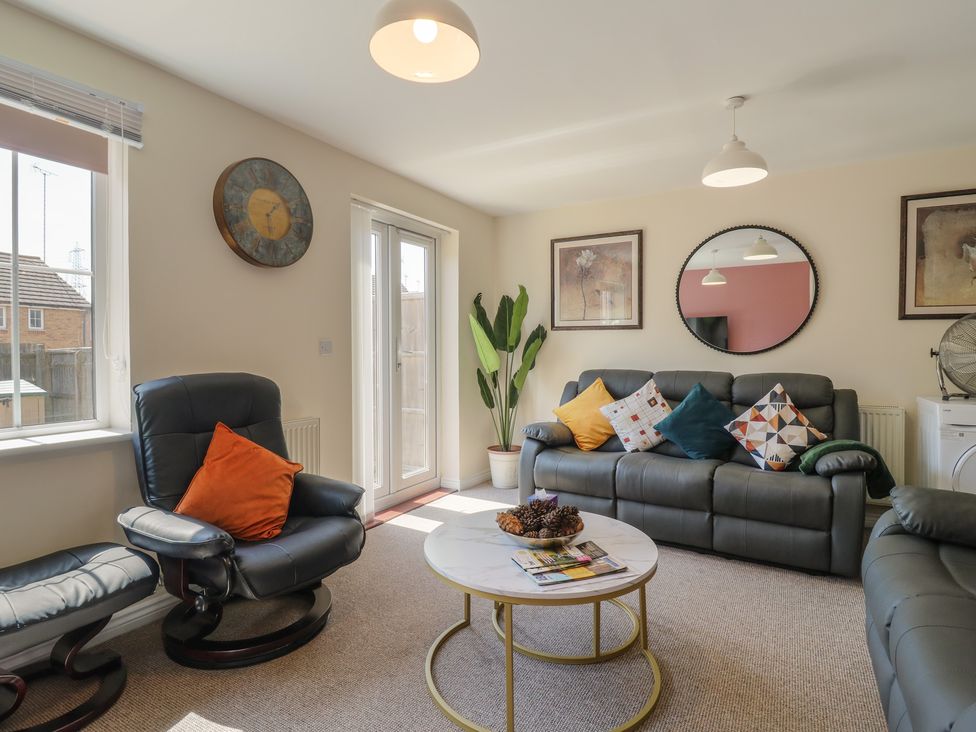 A living room with a sofa and coffee table at Gem Relax in Leighton Buzzard