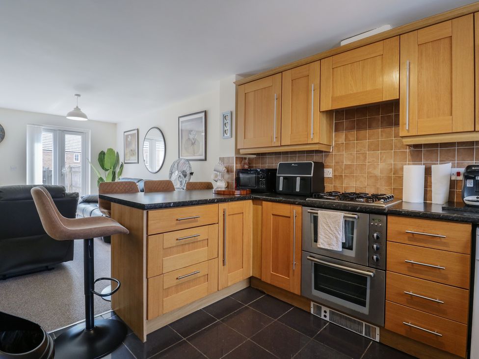 A kitchen with cabinets and appliances at Gem Relax in Leighton Buzzard