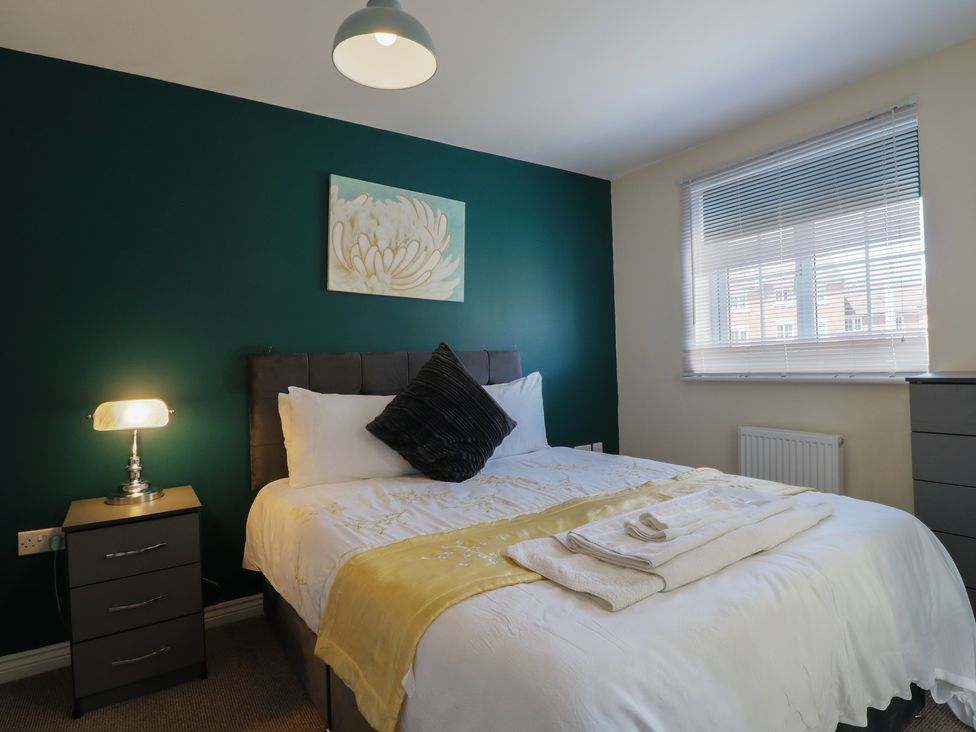 A bedroom with a bed and a nightstand at Gem Relax in Leighton Buzzard
