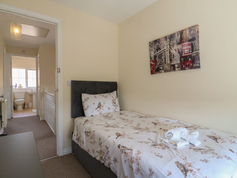 A bedroom with a bed and a bathroom visible at Gem Relax in Leighton Buzzard