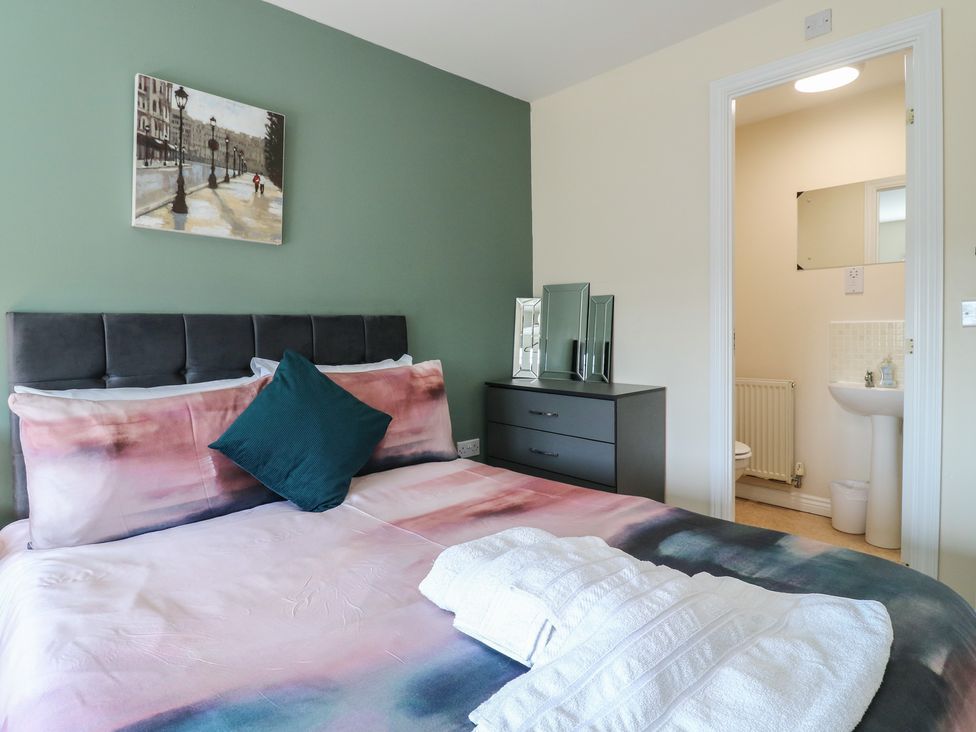 A bedroom with a bed and attached bathroom at Gem Relax in Leighton Buzzard