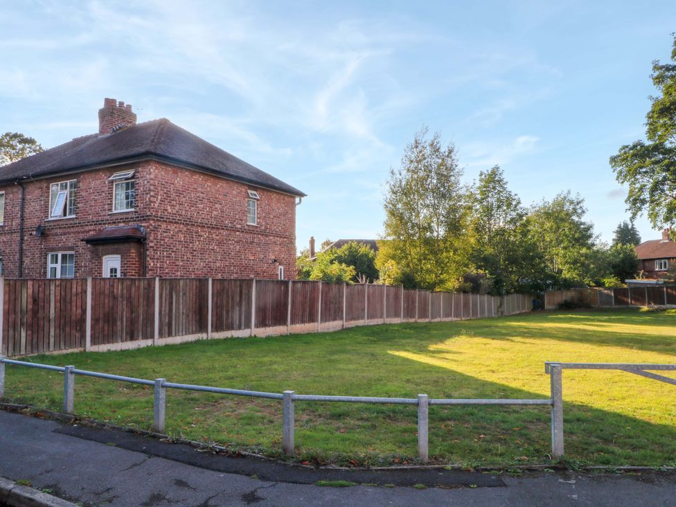 A house with a lawn and a fence at Ash House